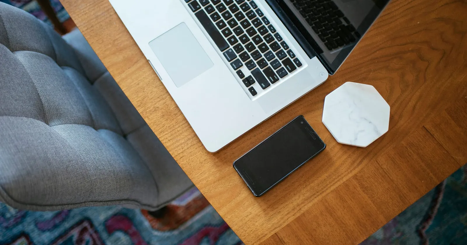 Image of a laptop and cell phone on a table